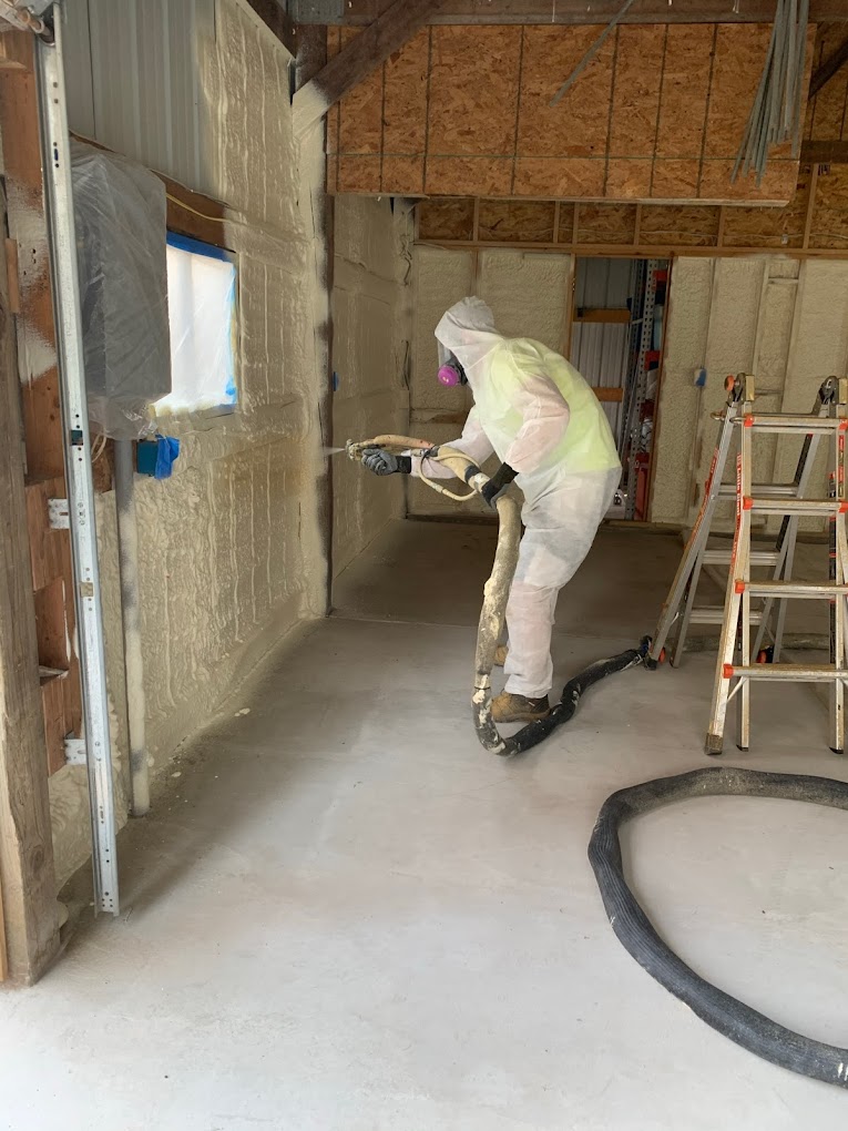 Isaiah Holbrook operating spray foam equipment in Shawano Wisconsin