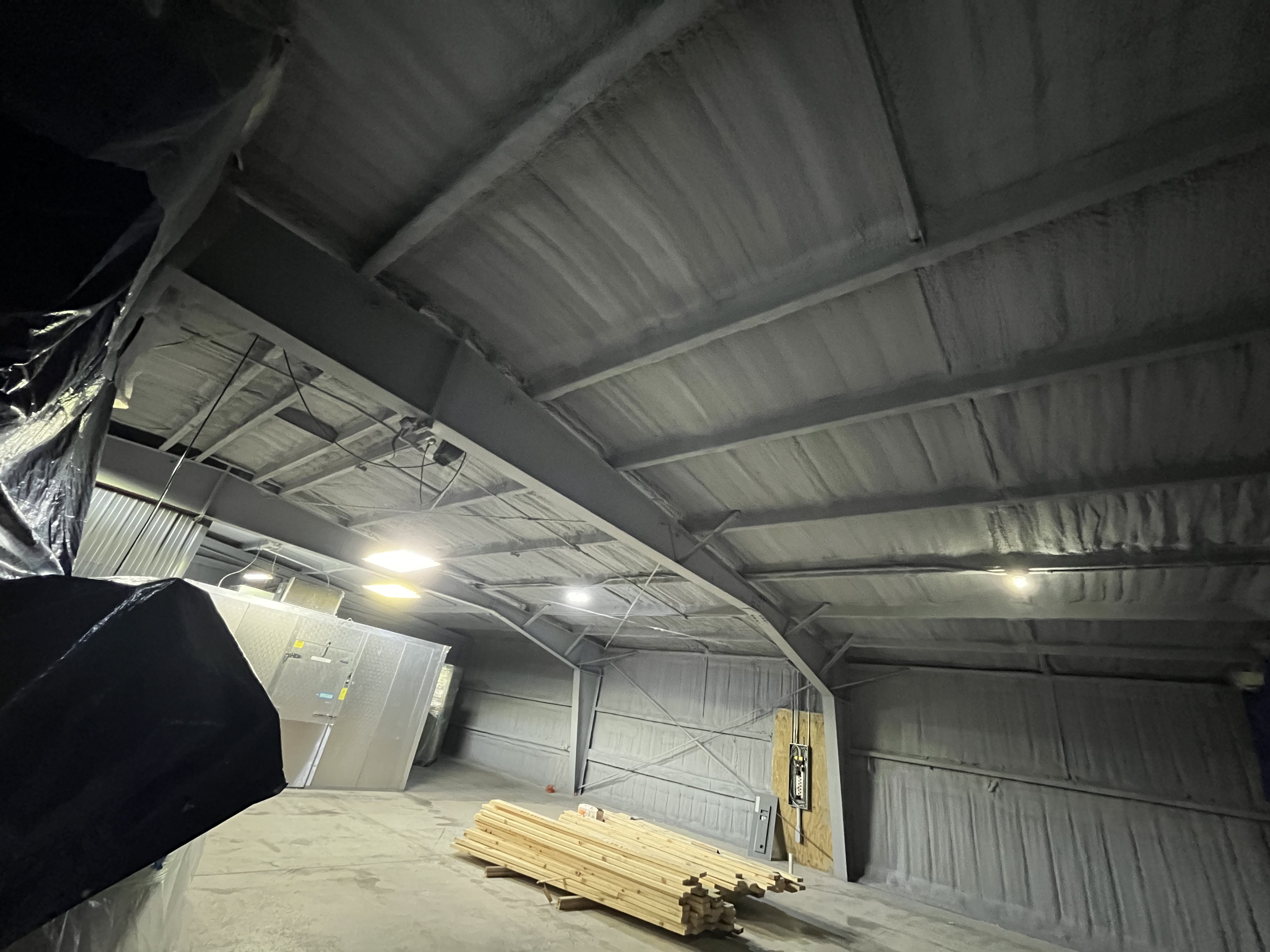 Steel shop interior spray foam ceiling in Wisconsin
